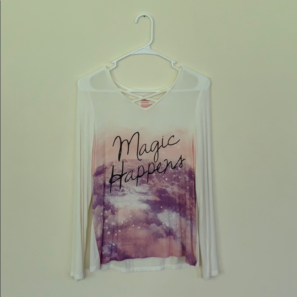 sweater says “magic happens”